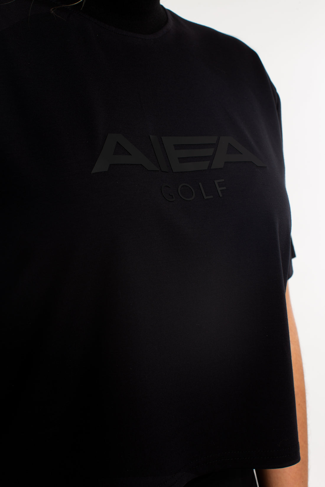 AIEA Golf cropped mock neck logo tee in black